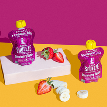 Load image into Gallery viewer, Two bright pink Mamma Chia Squeeze pouches on a colorful yellow and pink backdrop, with fresh strawberries and banana slices nearby, creating a vibrant, healthy snack vibe.